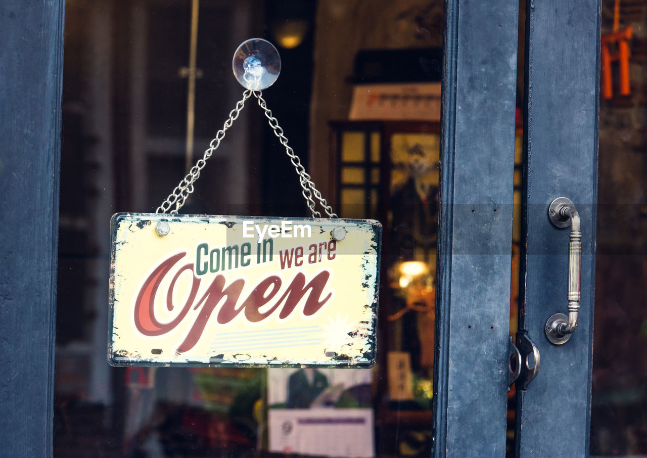 Close-up of open sign on door