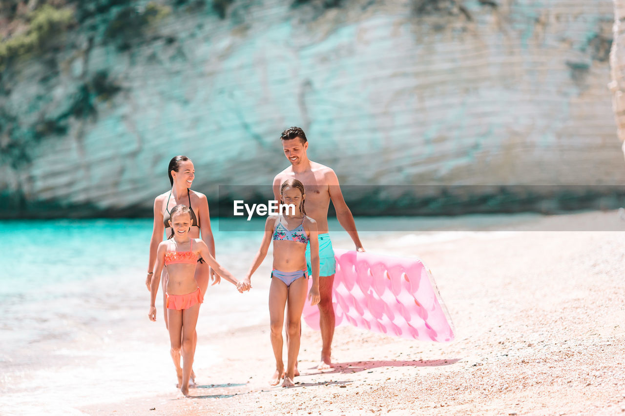 FRIENDS ENJOYING ON BEACH