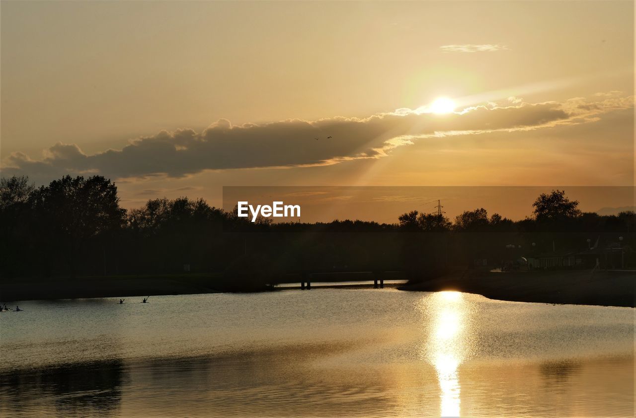 Scenic view of lake against sky during sunset
