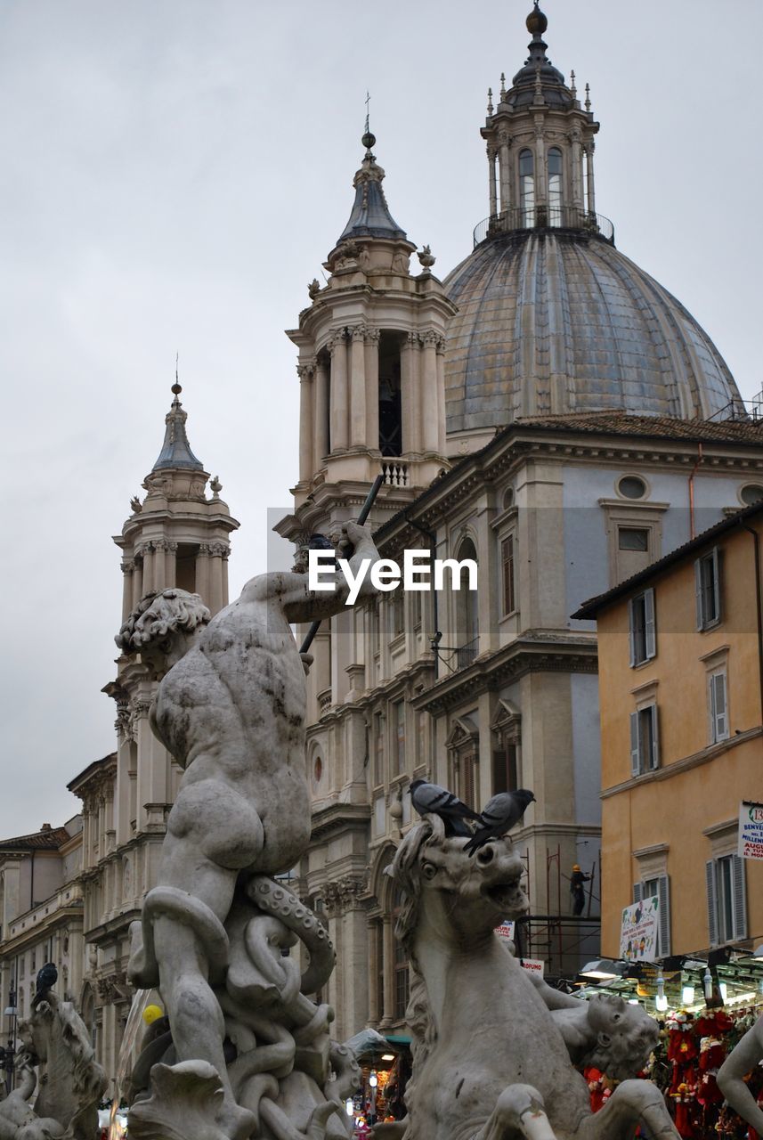 Low angle view of fontana del nettuno in piazza navona