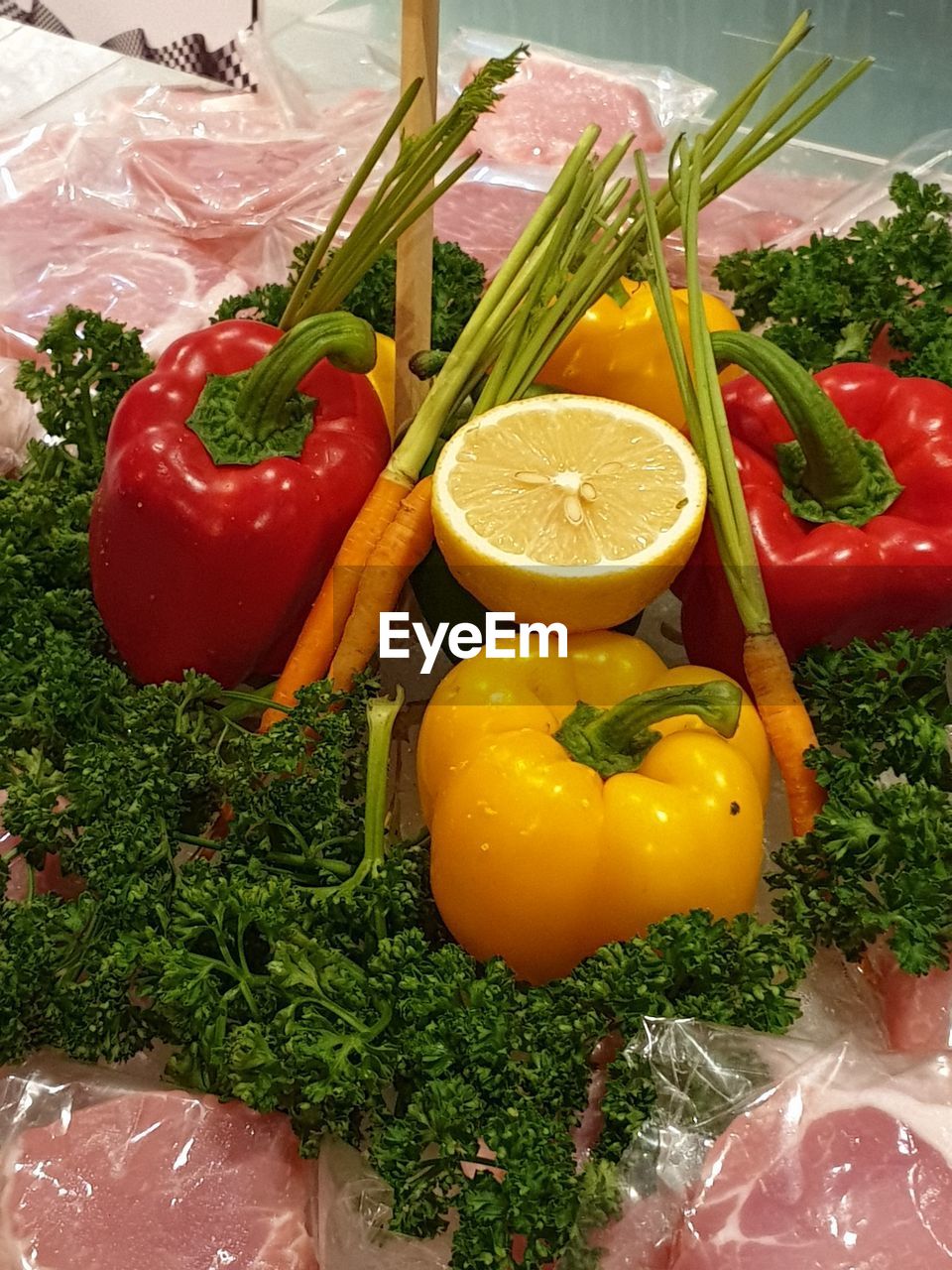 HIGH ANGLE VIEW OF BELL PEPPERS AND VEGETABLES IN BOX