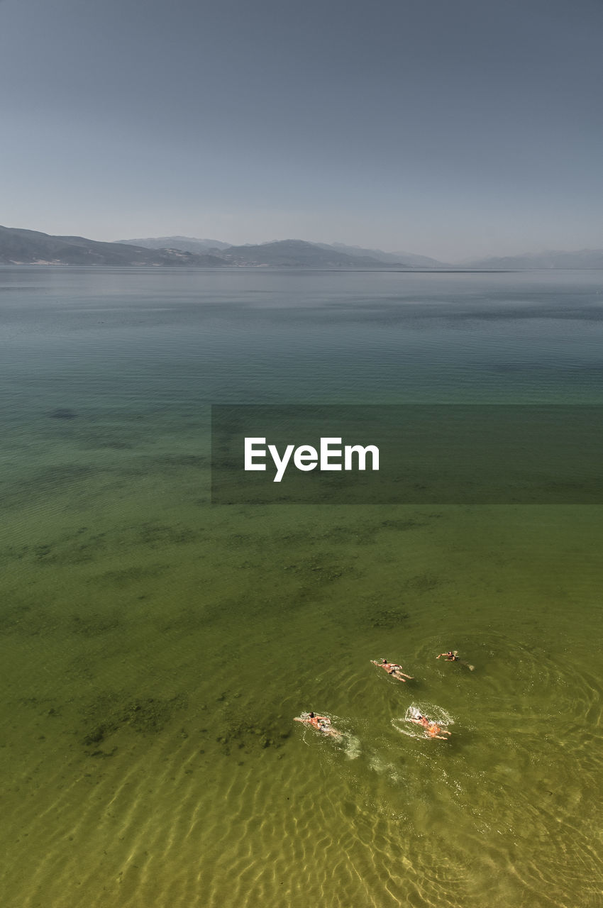 High angle view of people swimming in lake