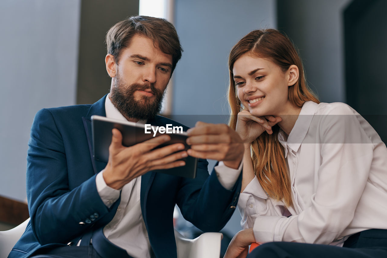 Business people using digital tablet at office