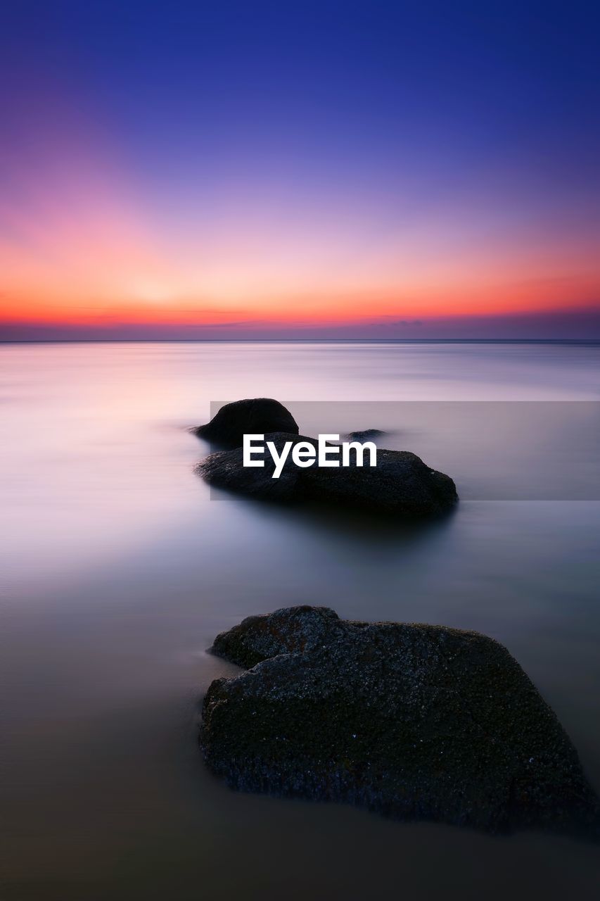 Scenic view of sea against sky at sunset