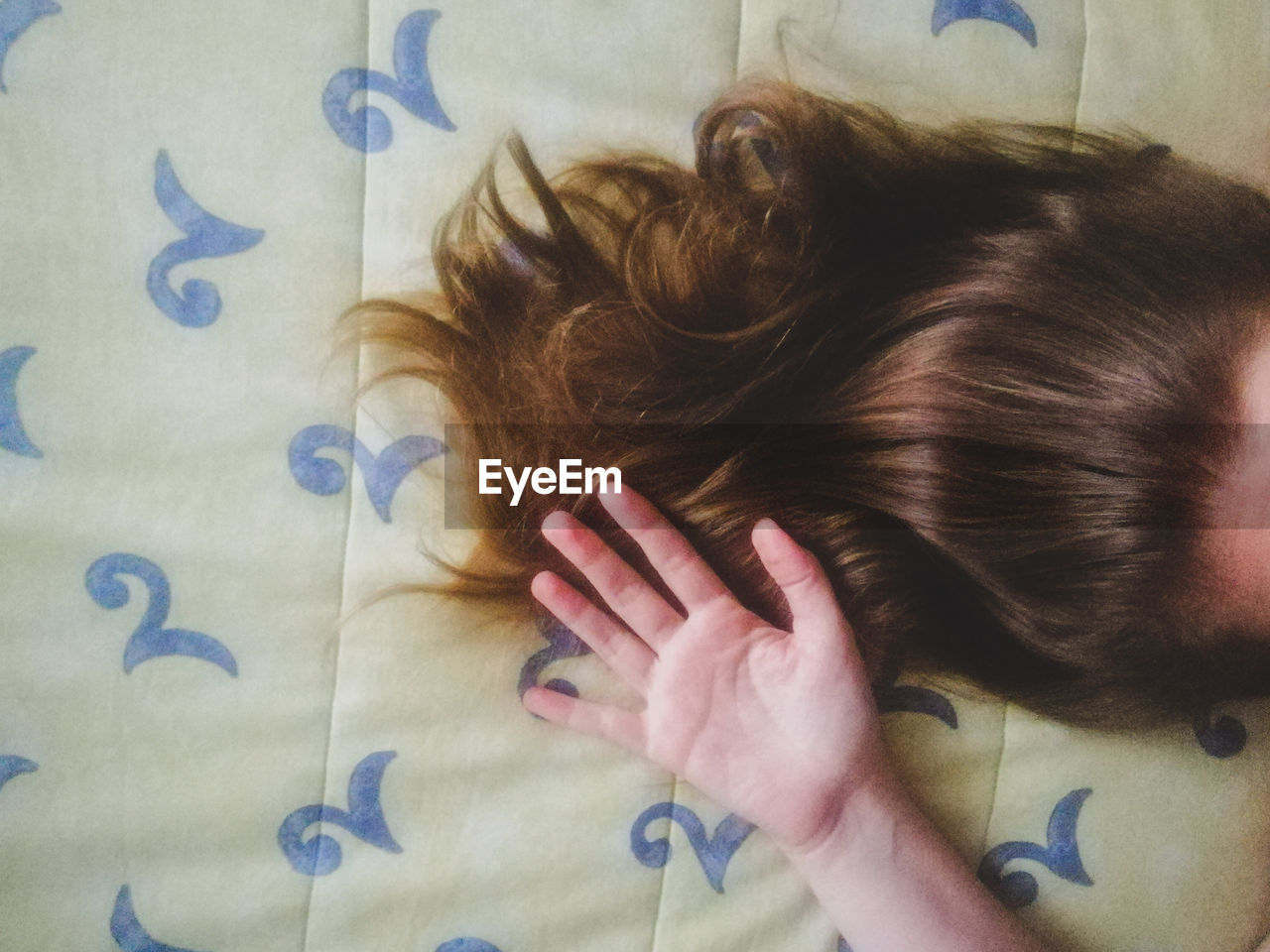 Directly above shot of woman on bed at home