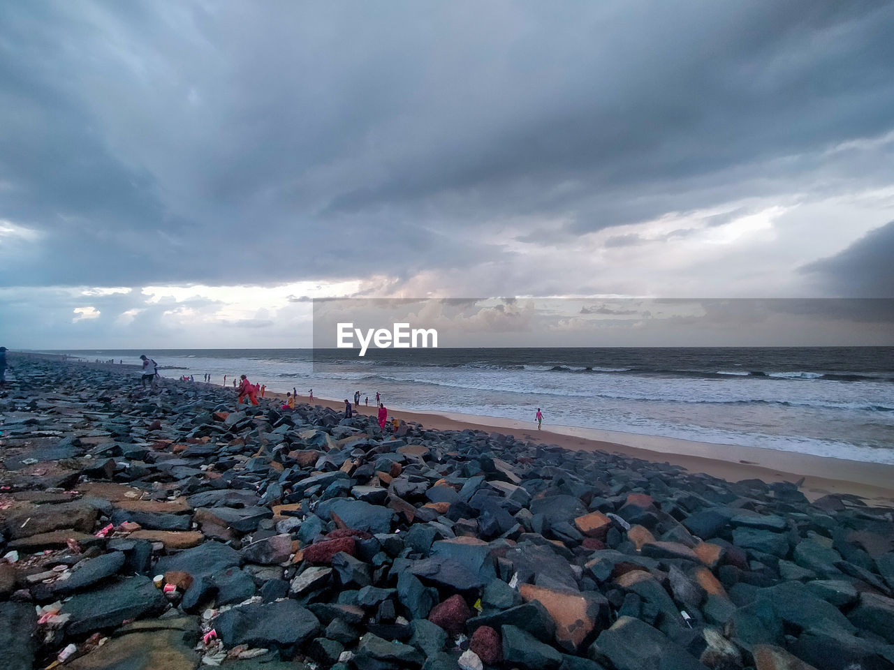 sea, sky, water, land, beach, cloud, coast, shore, ocean, body of water, horizon, wave, nature, beauty in nature, scenics - nature, environment, travel destinations, wind wave, horizon over water, dramatic sky, rock, coastline, sand, outdoors, travel, seascape, storm, bay, sunset, tranquility, architecture, no people, pebble, tourism, landscape, holiday, water's edge, dusk, overcast, motion, tranquil scene, trip, vacation, day