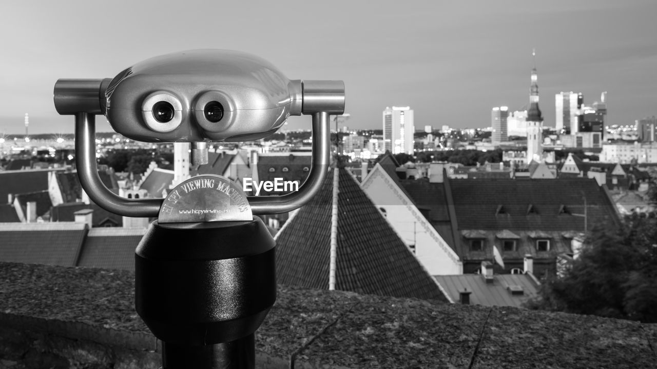 Coin-operated binocular against cityscape