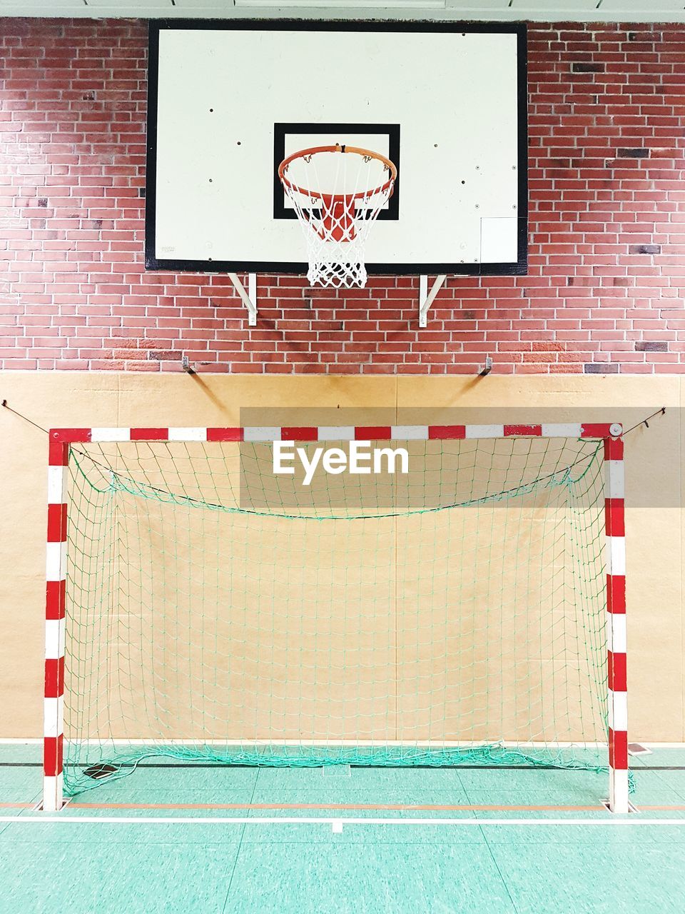 View of basketball hoop against brick wall