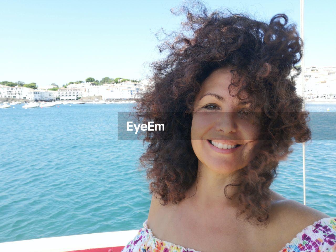 Portrait of smiling woman against sea and sky