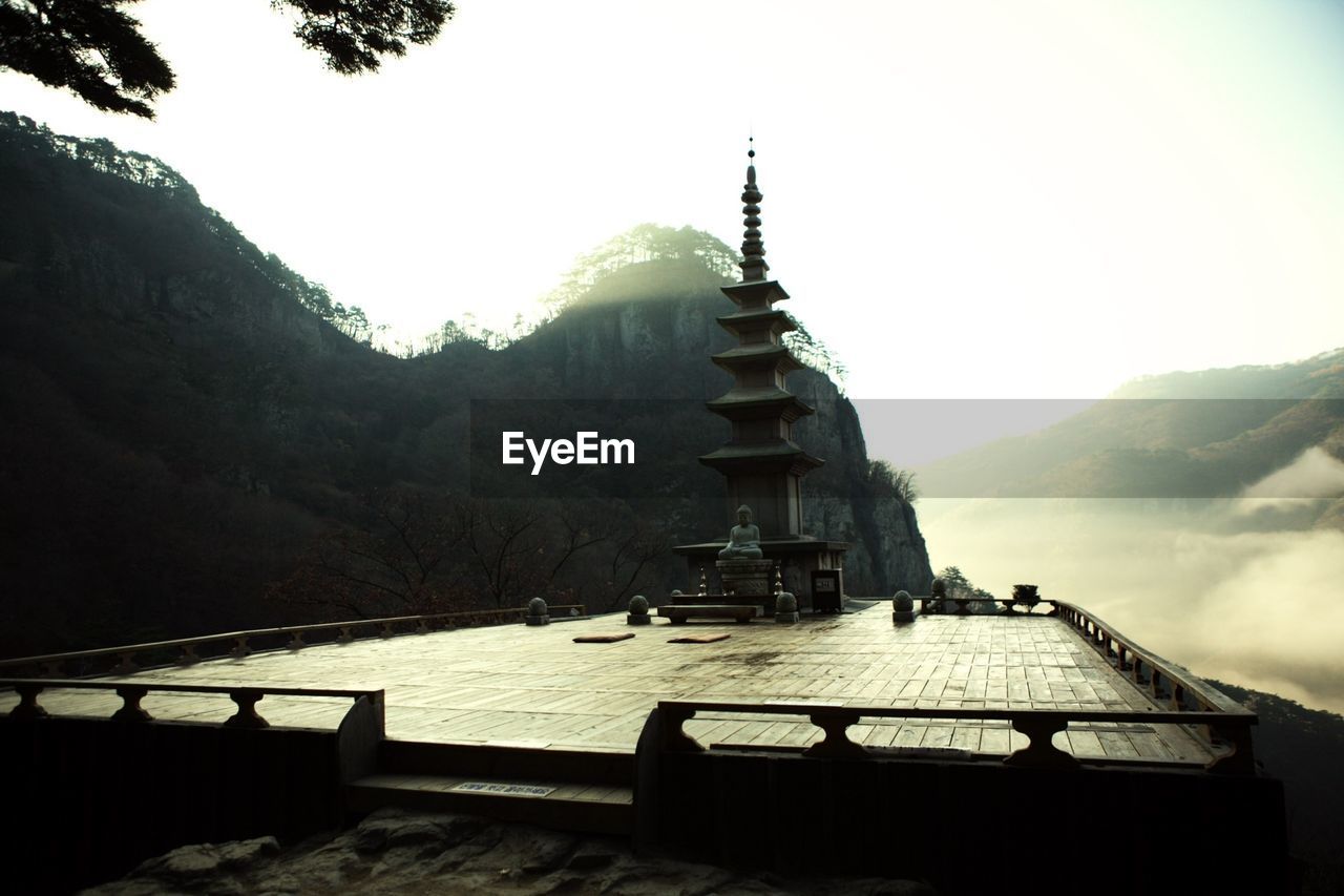 Religious structure against mountain and clear sky