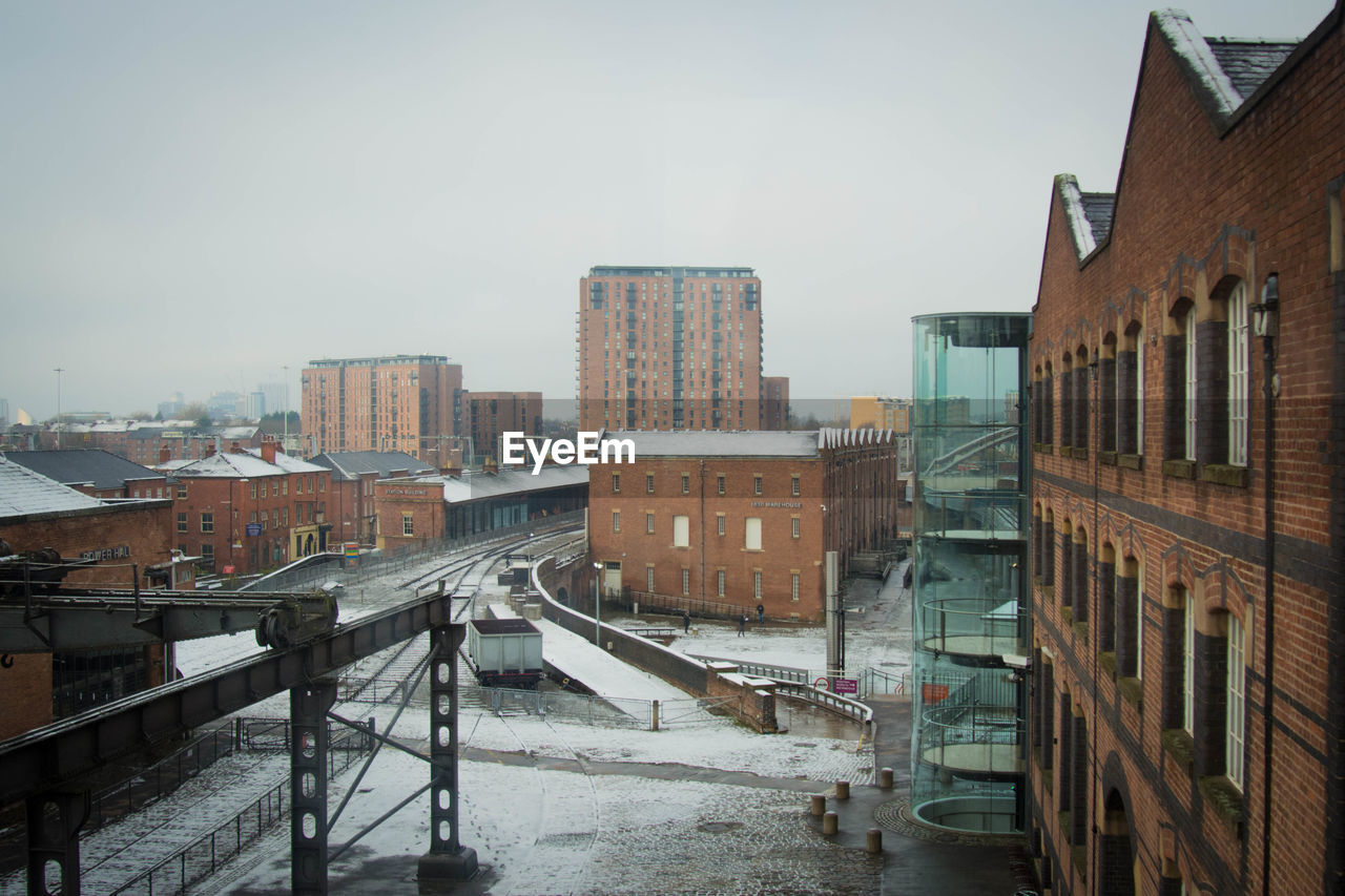 High angle view of street amidst buildings against sky