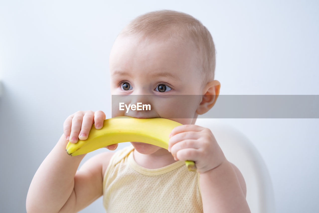 Cute girl biting banana