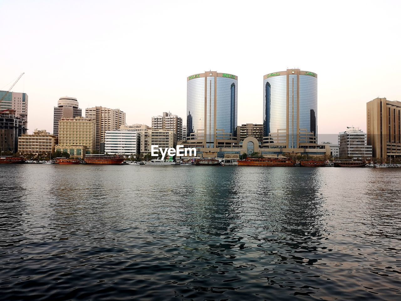 RIVER BY BUILDINGS AGAINST CLEAR SKY