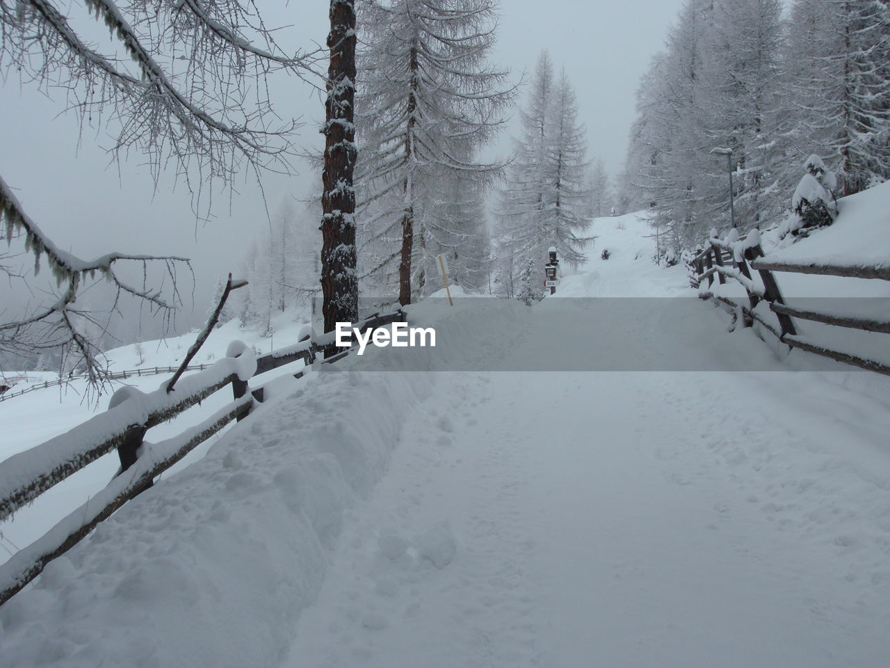 Snow covered landscape against sky