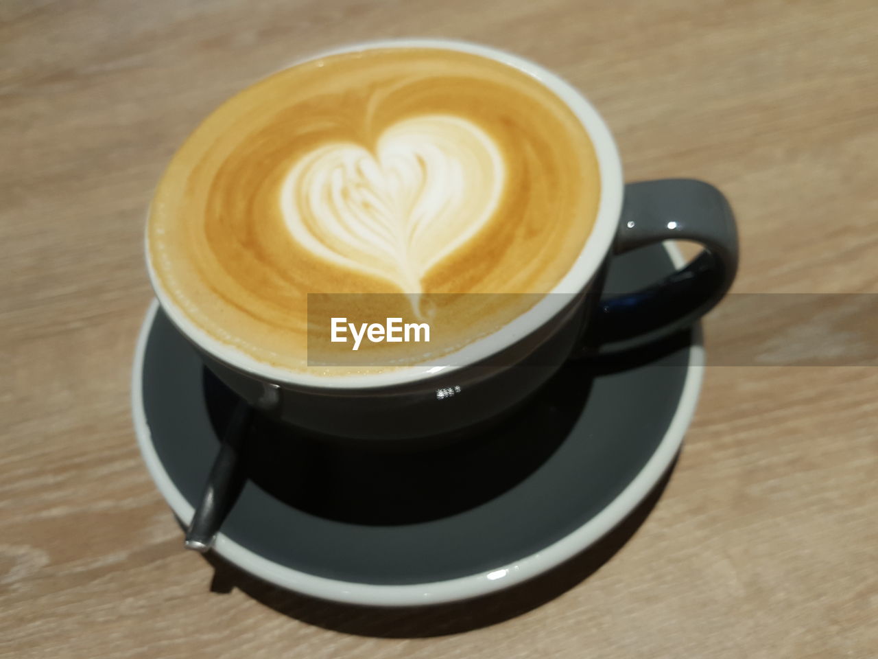 CLOSE-UP OF COFFEE CUP ON TABLE