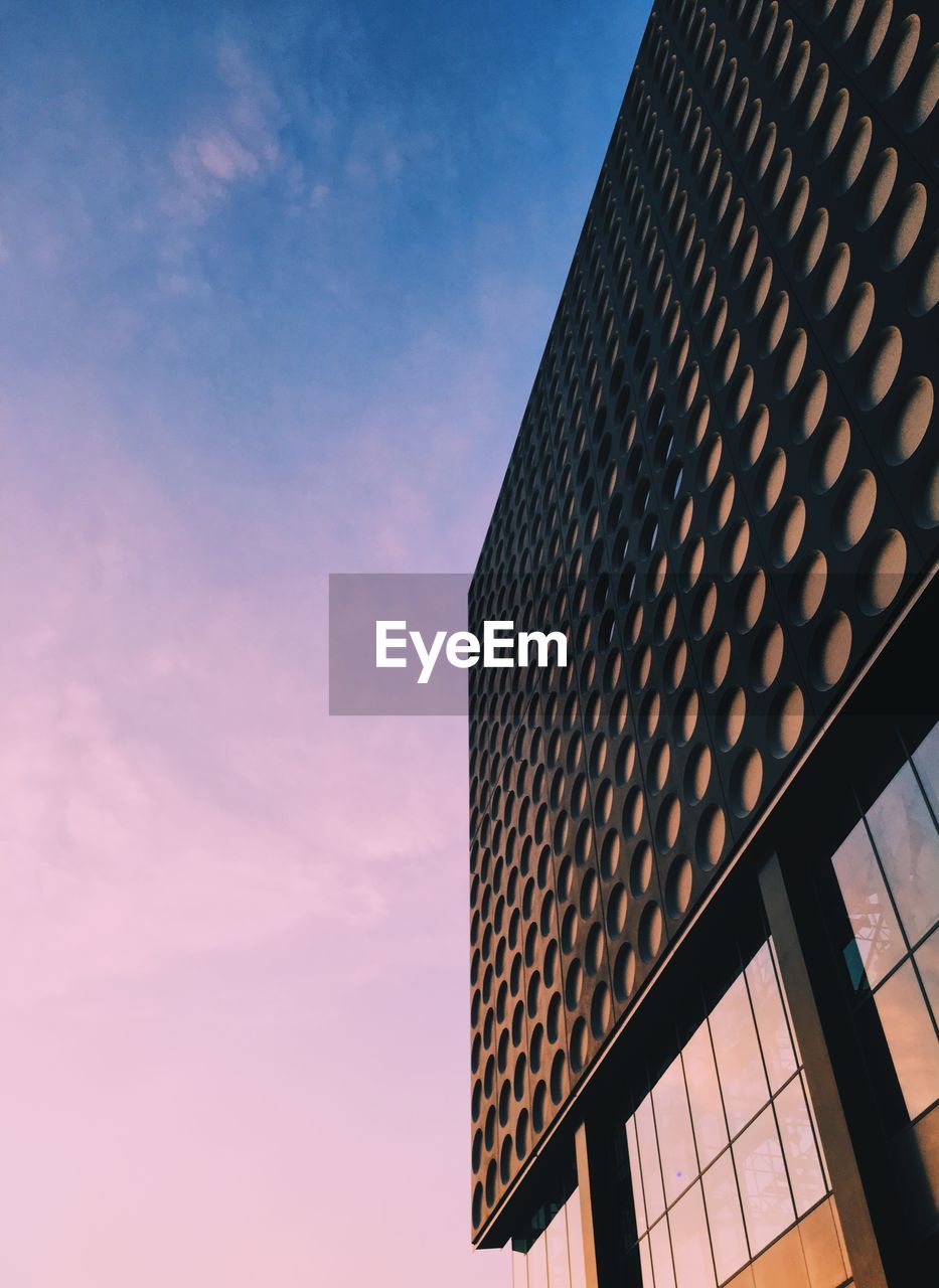 Low angle view of building against sky during sunset