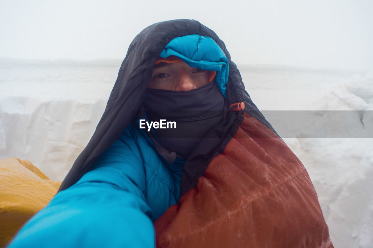 Portrait of man on snow covered field during winter