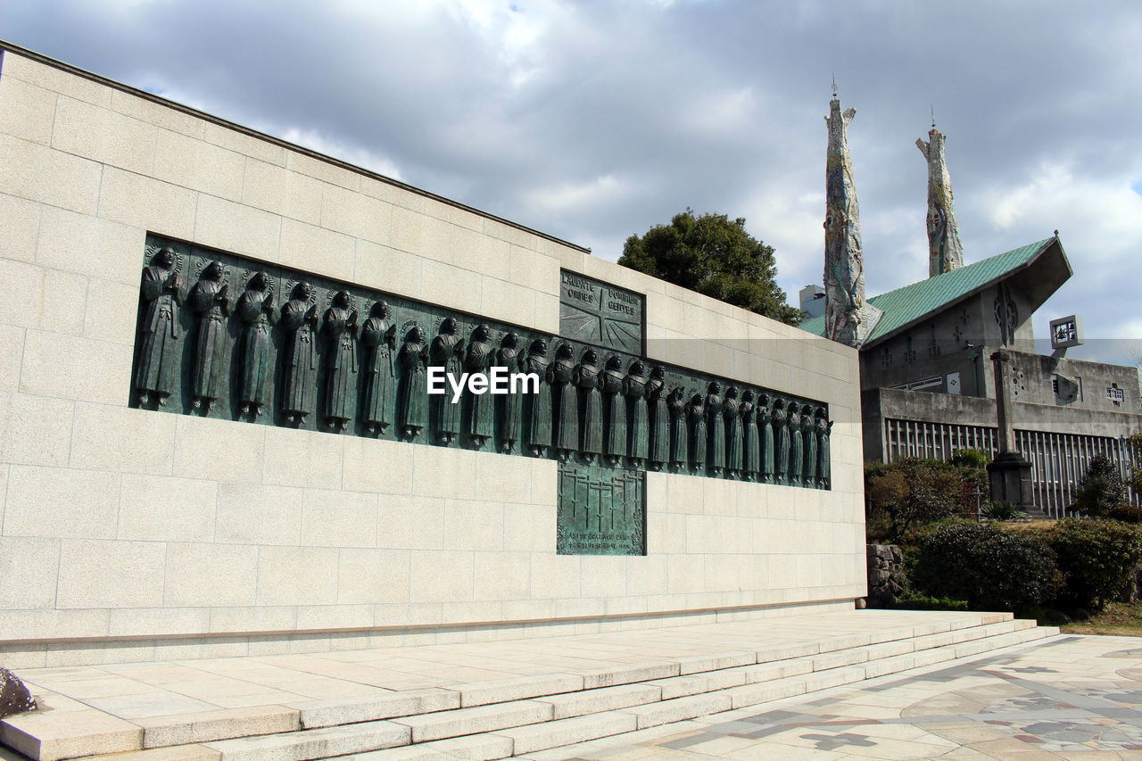 EXTERIOR OF BUILDING AGAINST CLOUDY SKY