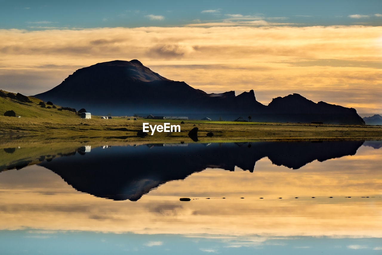 SCENIC VIEW OF LAKE BY MOUNTAIN AGAINST SKY