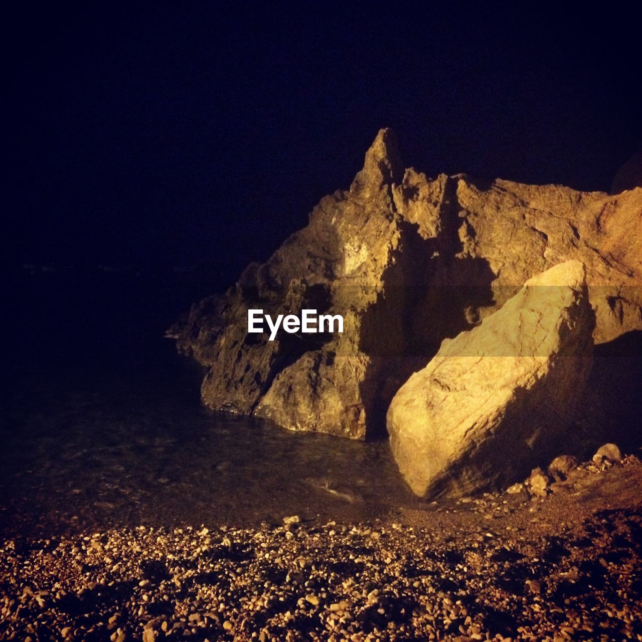 Rock formation on water in cave