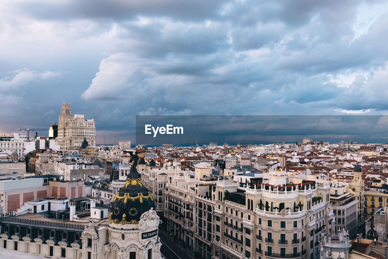 High angle view of cityscape against cloudy sky