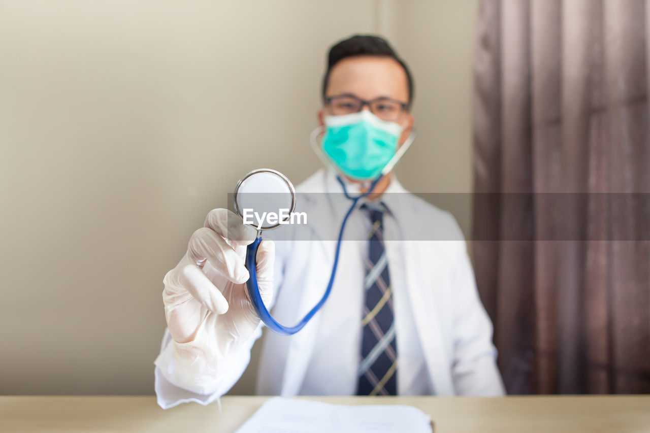 Portrait of doctor holding stethoscope in clinic