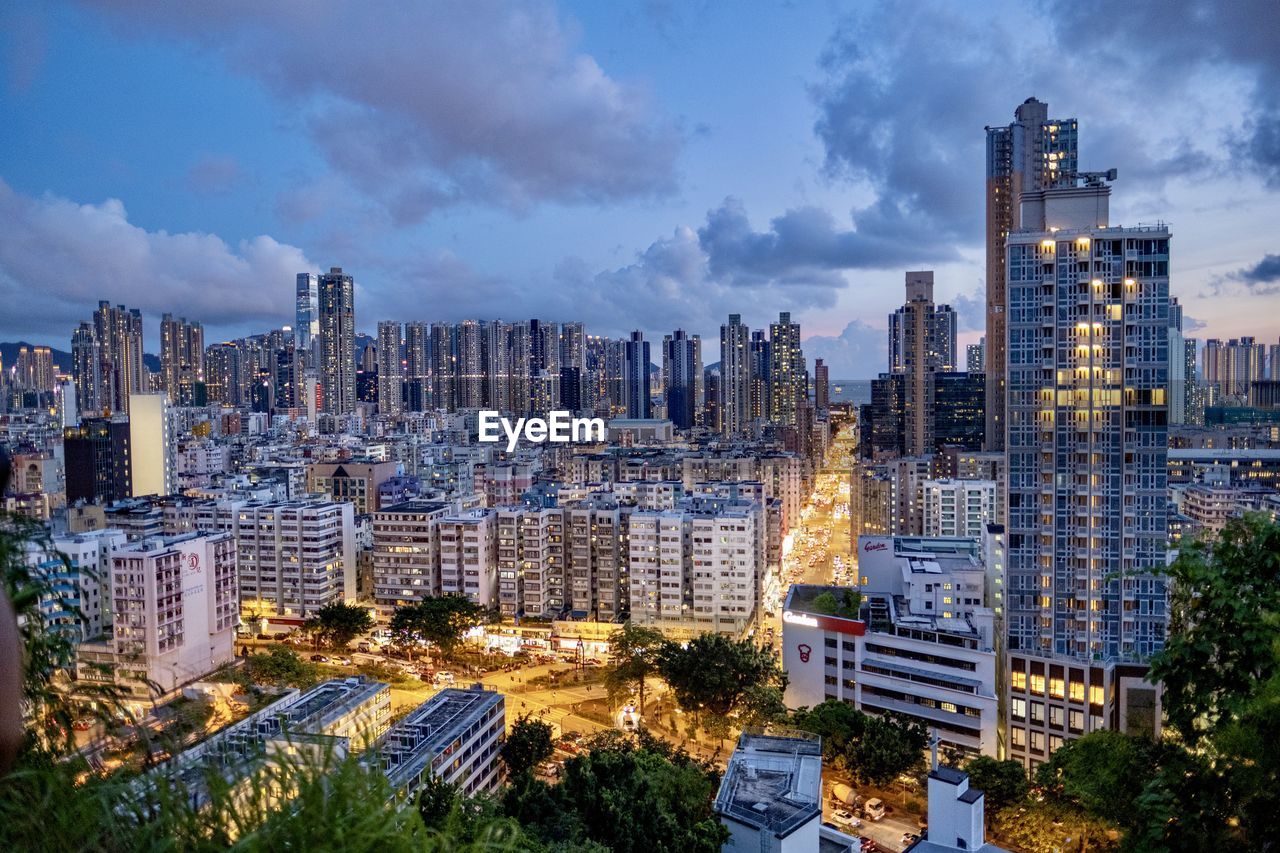 Evening of garden hill, hong kong. a dense district with old and modern buildings behind.