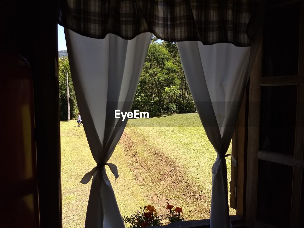 CLOSE-UP OF WINDOW WITH UMBRELLA