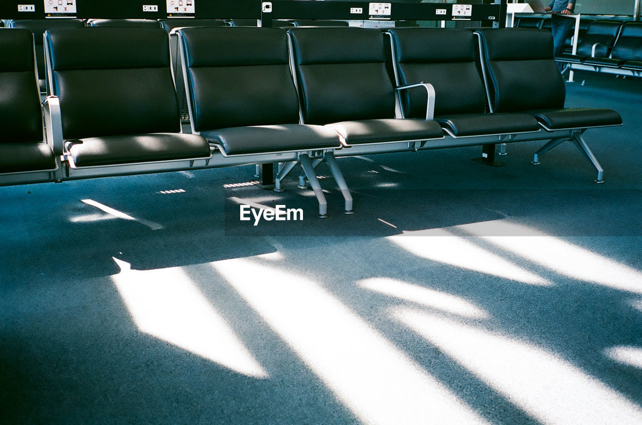 Empty chairs in airport departure room