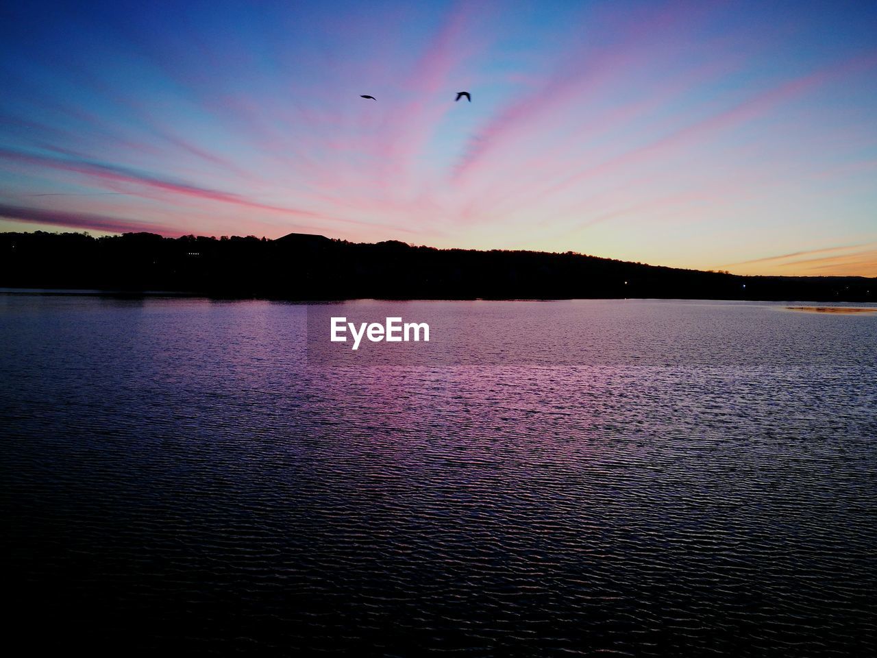 VIEW OF LAKE AGAINST SKY DURING SUNSET