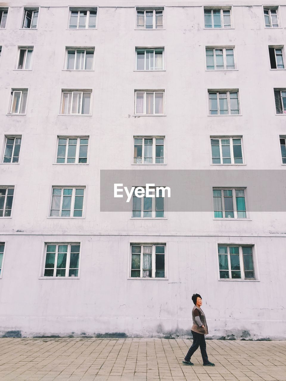 YOUNG WOMAN STANDING IN BUILDING