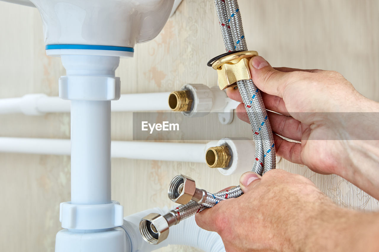 cropped hand of person holding faucet