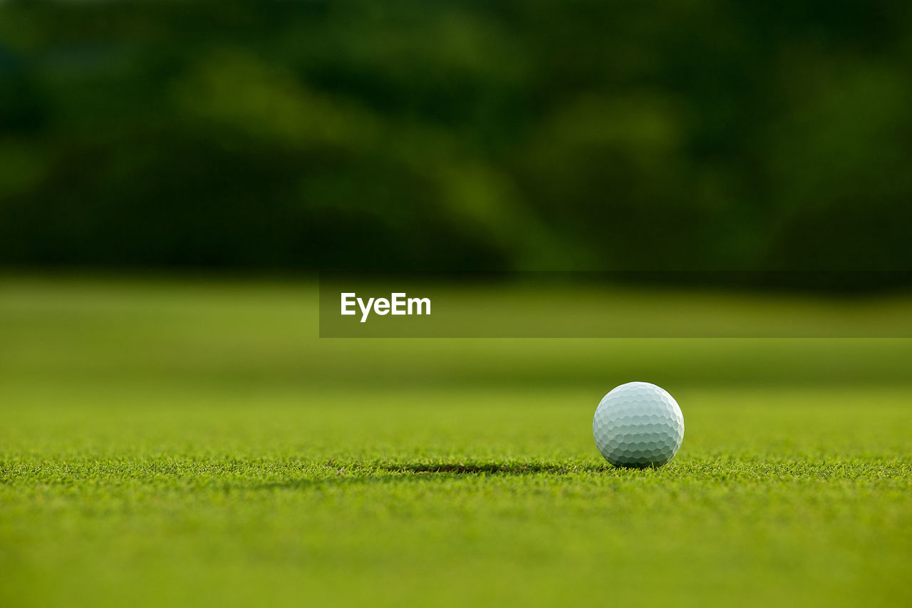 Close-up of golf ball on playing field