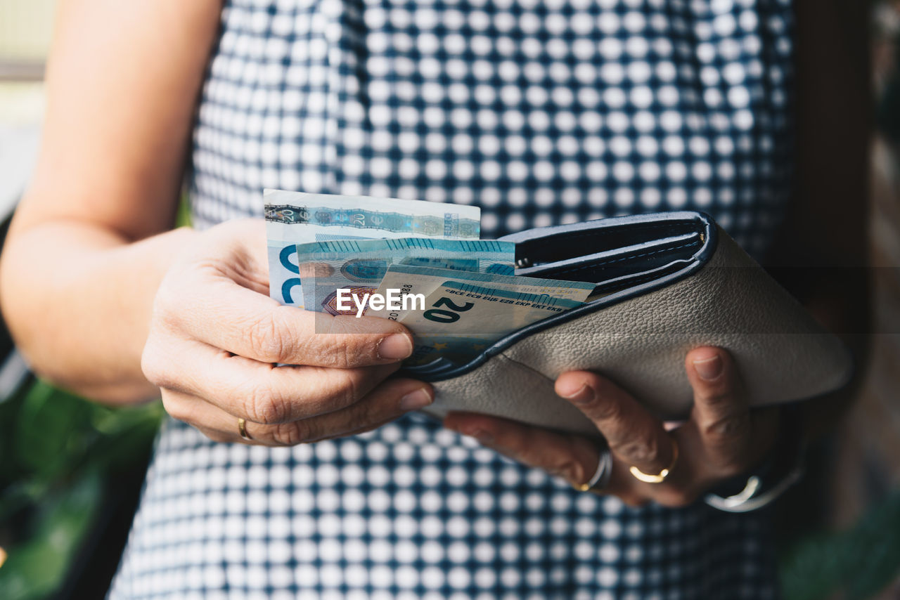 Close-up of woman holding wallet