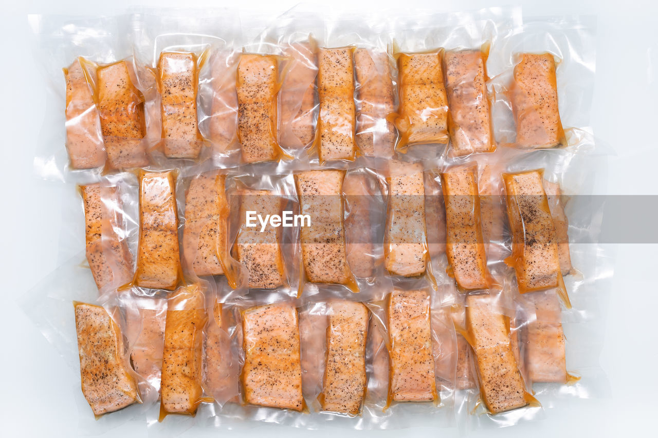 Freeze cooked salmon in vacuum packs on grunge table, concept of food preservation