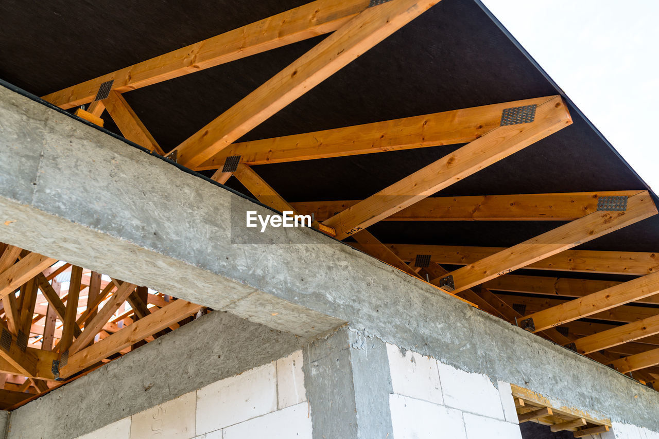 Roof trusses covered with a membrane on a detached house under construction, visible roof elements