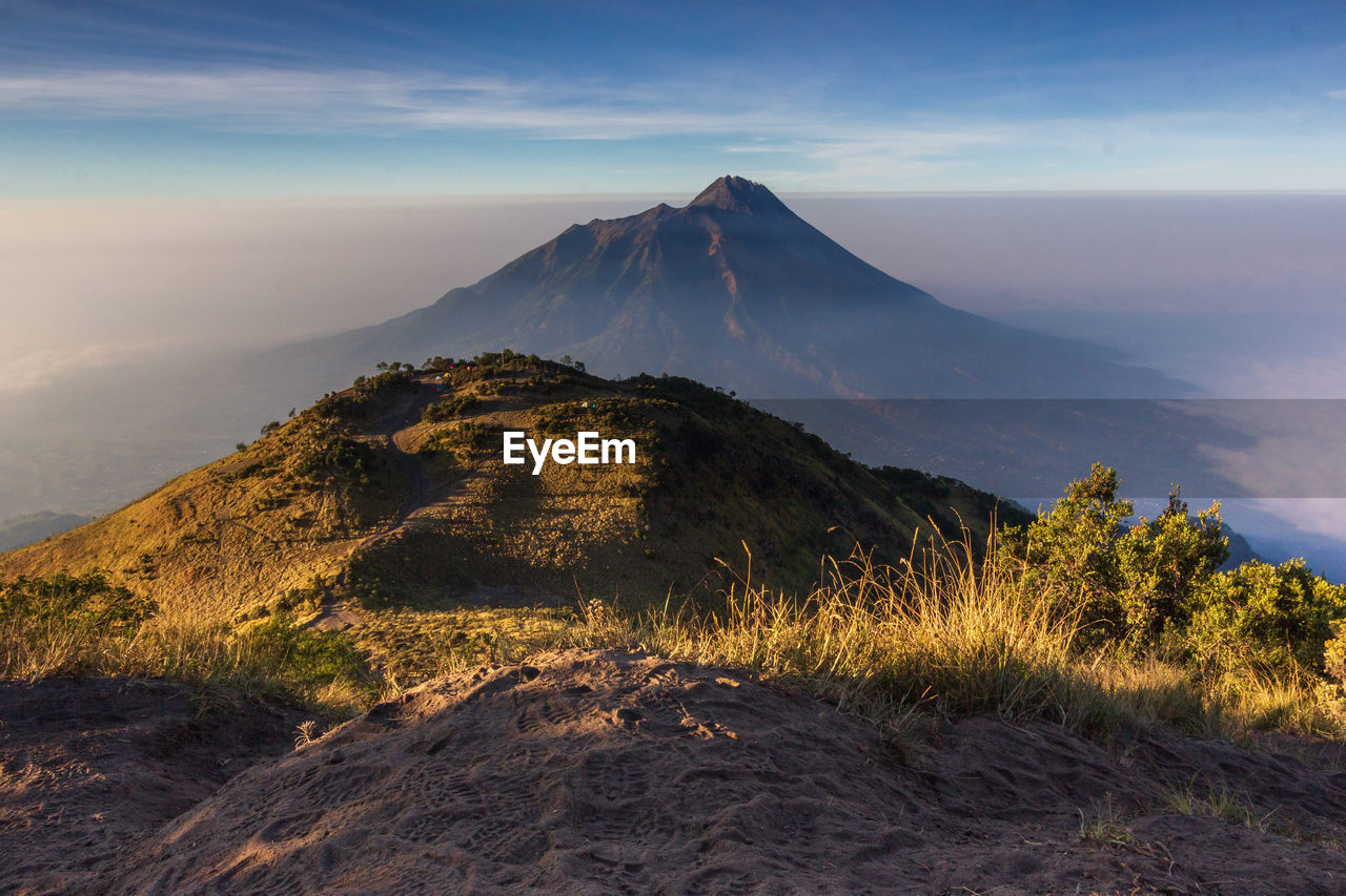 Scenic view of landscape against cloudy sky