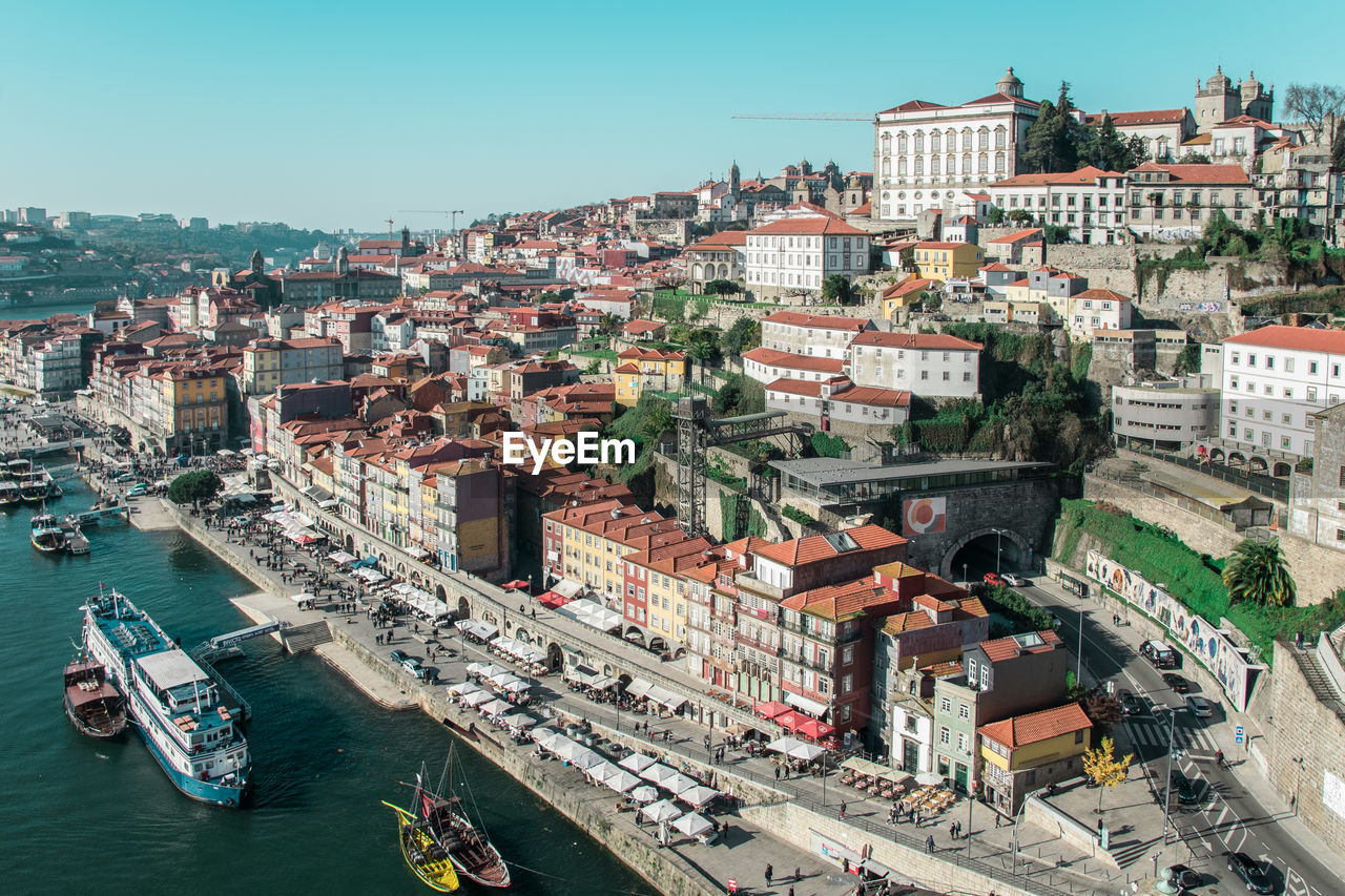 High angle view of boats moored on douro river by buildings against sky