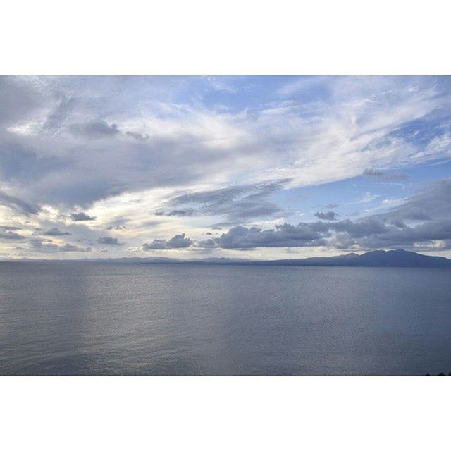 SCENIC VIEW OF SEASCAPE AGAINST CLOUDY SKY