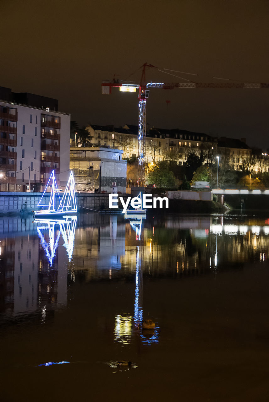 Illuminated city against sky at night