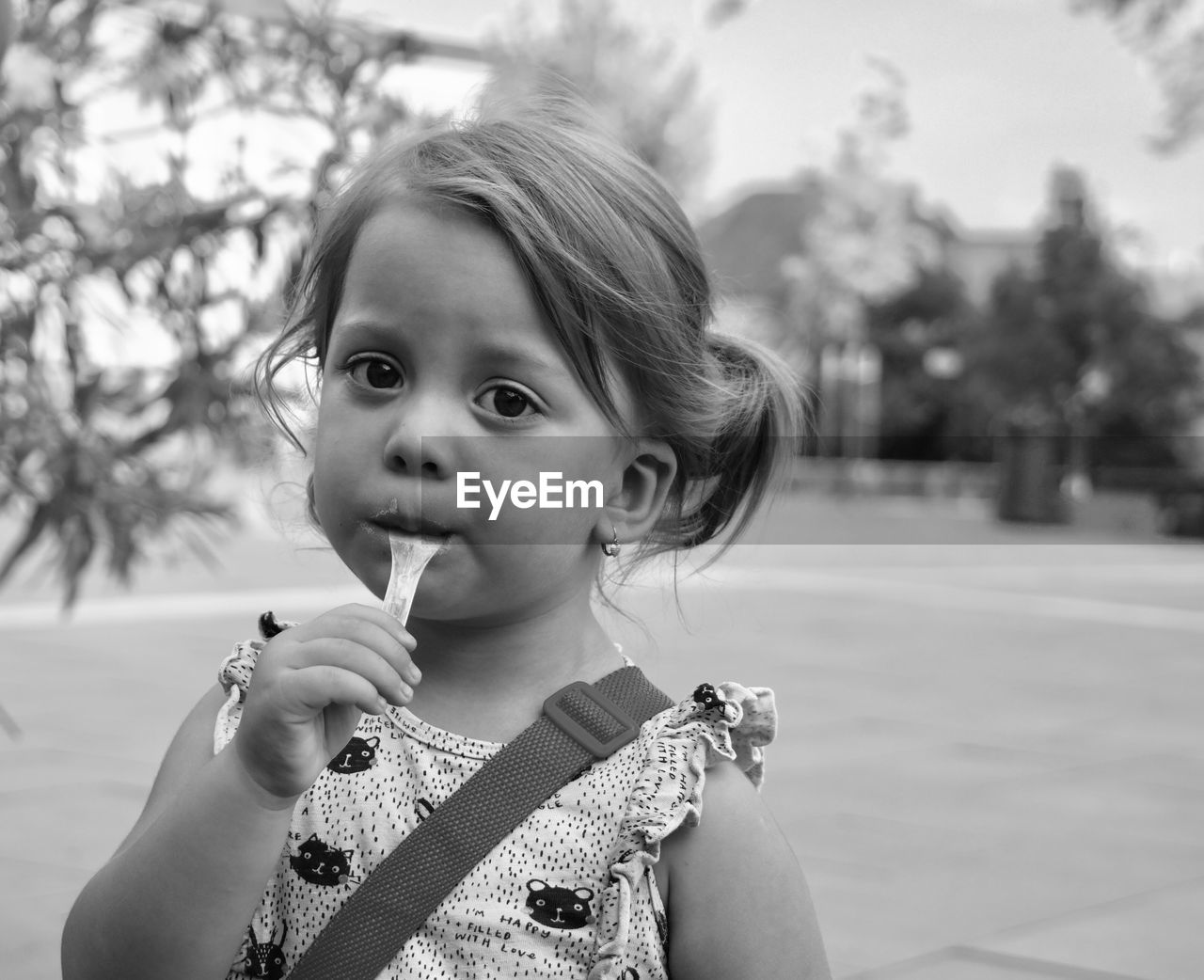 PORTRAIT OF A GIRL HOLDING CAMERA