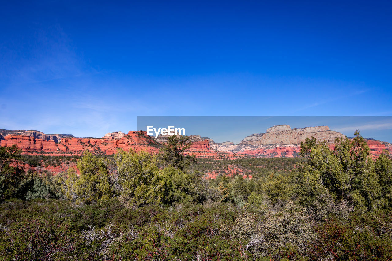 Scenic view of mountain against blue sky