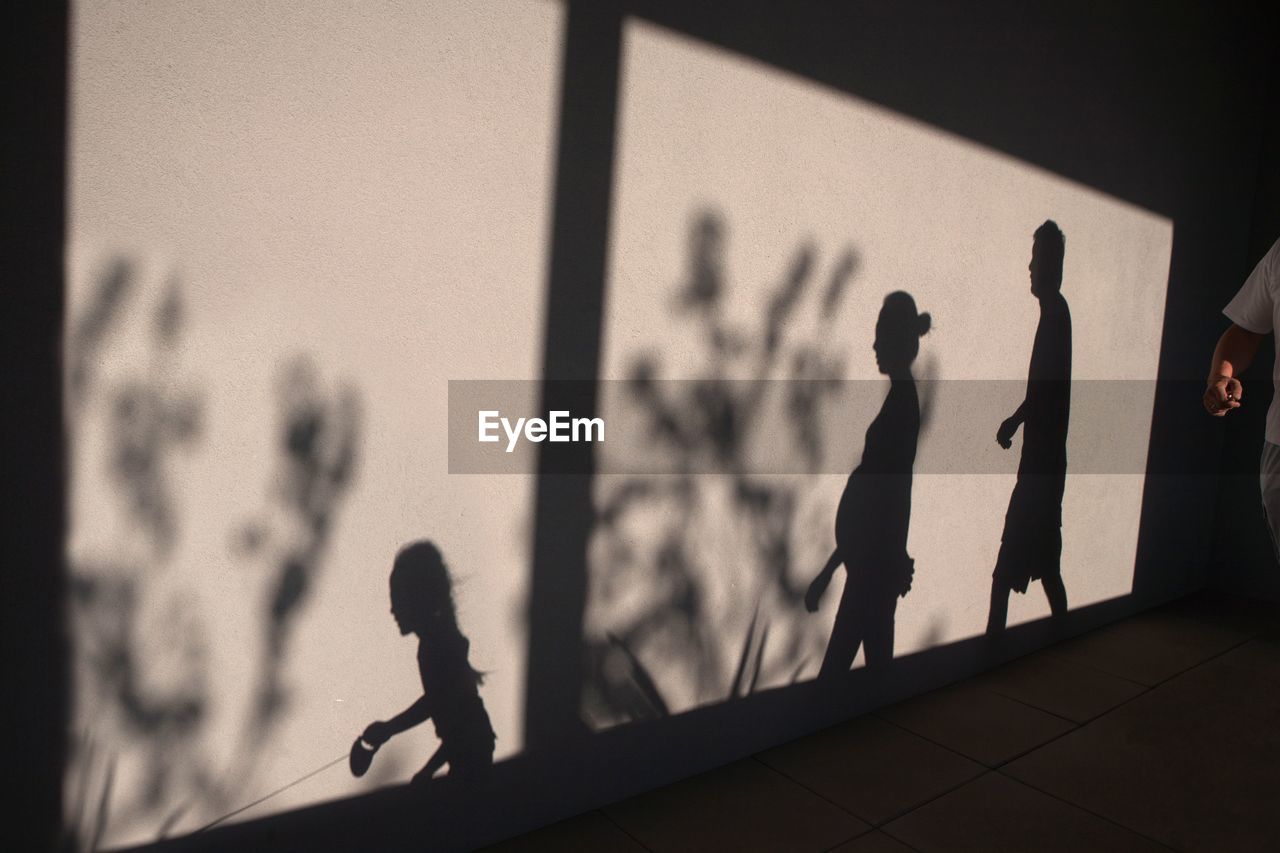 Shadow of family on wall