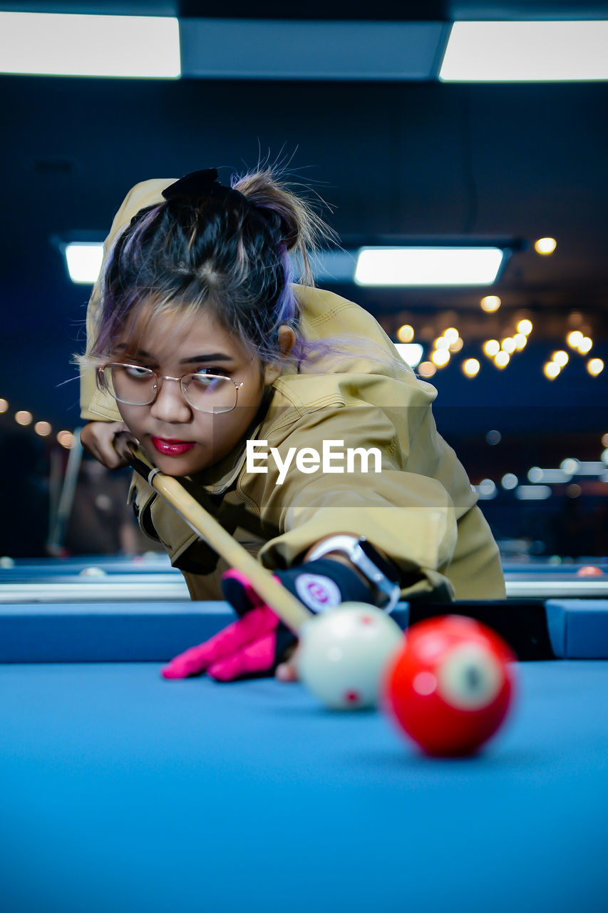 portrait of girl playing pool at home