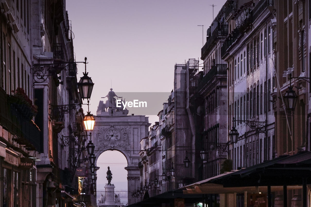 Low angle view of buildings in city against clear sky