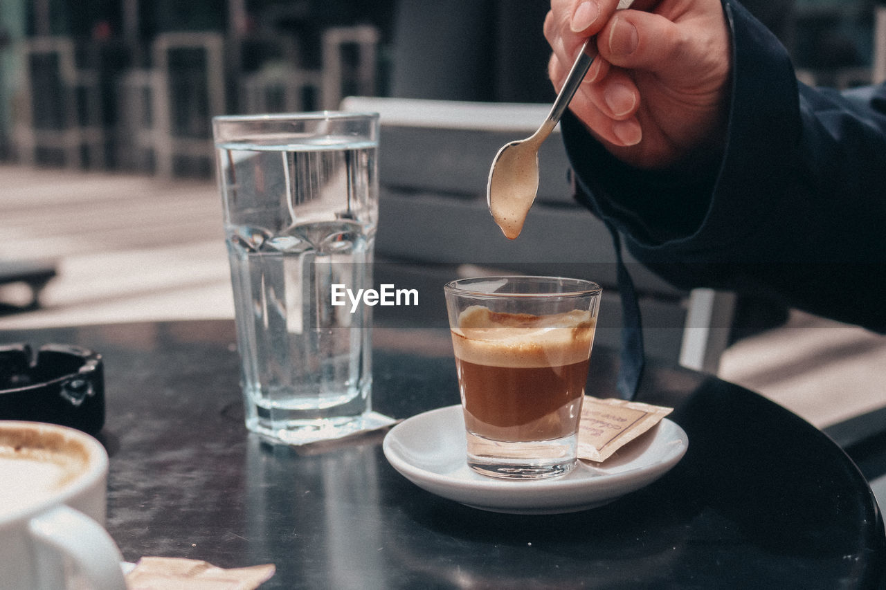 Midsection of woman having drink