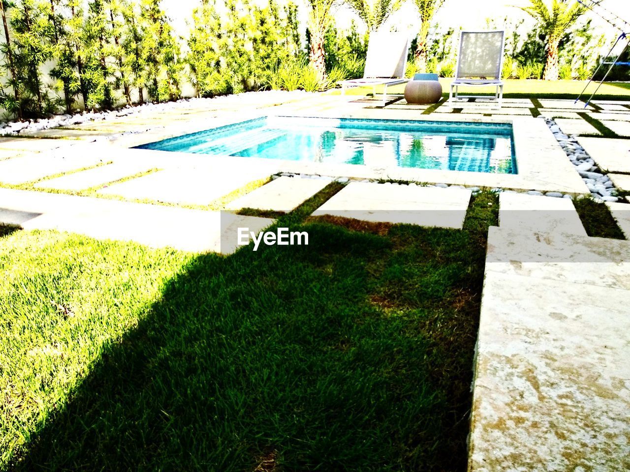 HIGH ANGLE VIEW OF BENCH IN LAWN