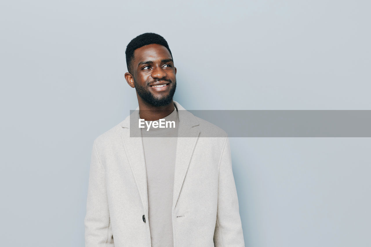 portrait of businessman standing against white background