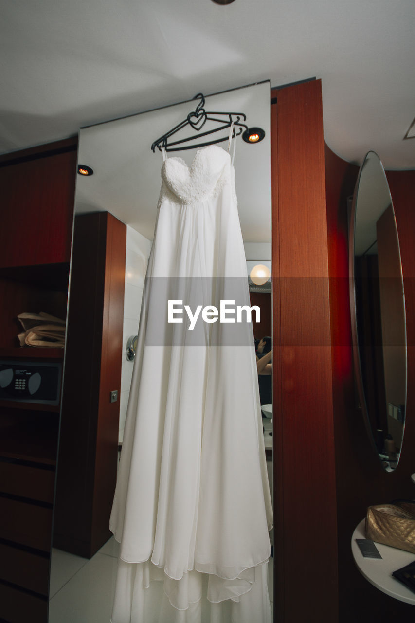 Wedding dress hanging on mirror