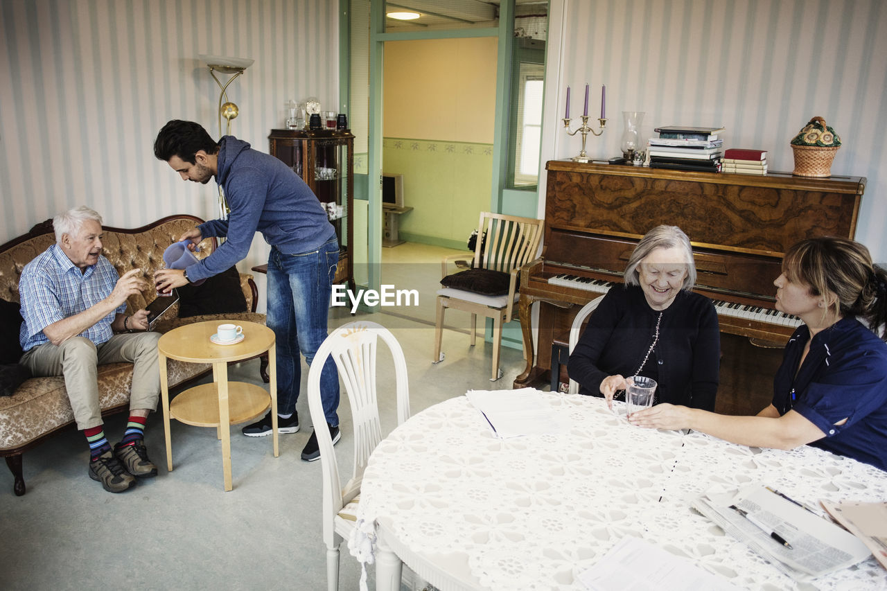 Caretakers taking care of senior people at nursing home